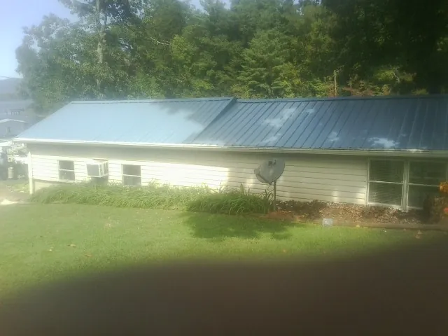 Blue metal roof running the length of a single story home in Hastings